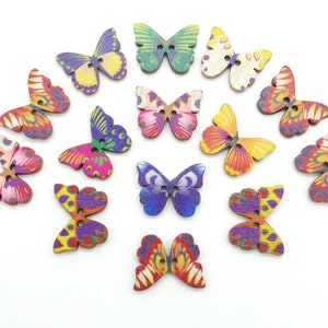 May include: Assortment of 15 wooden butterfly buttons in various colors and patterns, including pink, purple, blue, green, yellow, and orange.