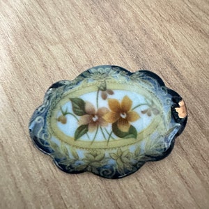 small enamel brooch with floral design