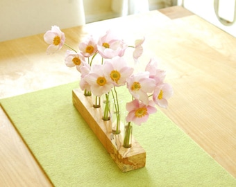 Flower meadow, vase with test tubes, flower vase