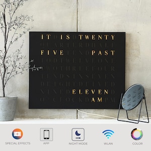 Horloge murale LED élégante WordClock Jupiter en acier inoxydable découpé au laser, finition noir mat et argent - affichage en anglais - contrôle via application