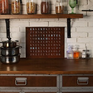 May include: A rusty metal sign with the word "VIERTEL" highlighted in blue. The sign is surrounded by jars of spices and other kitchen items.