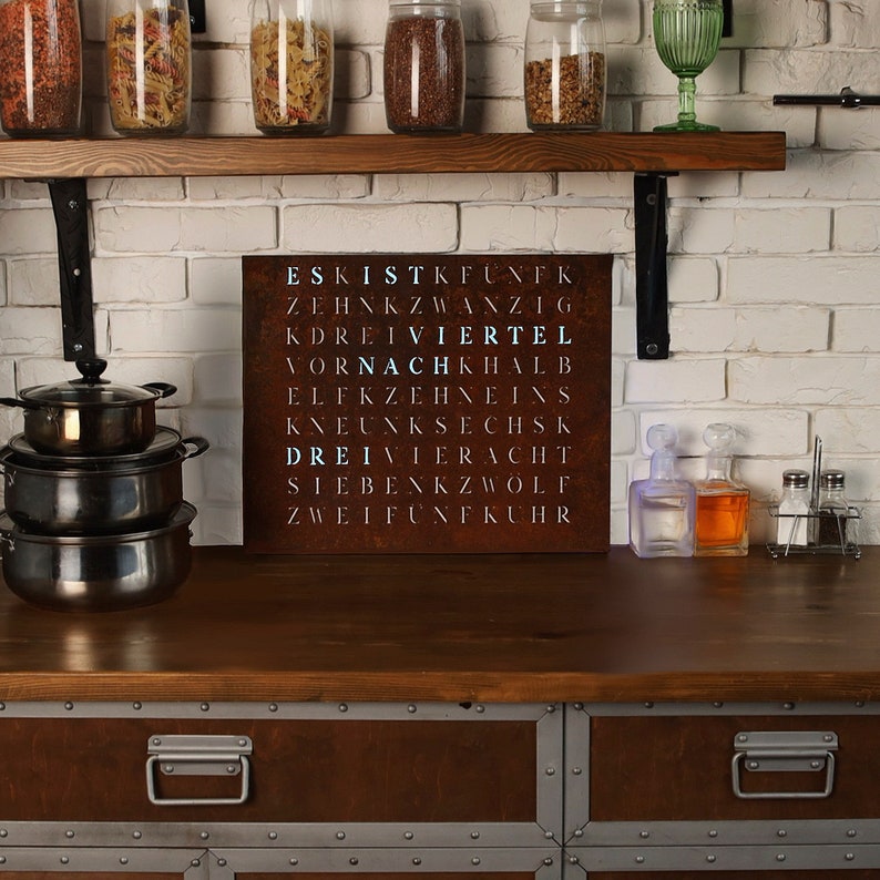 May include: A rusty metal sign with the word "VIERTEL" highlighted in blue. The sign is surrounded by jars of spices and other kitchen items.