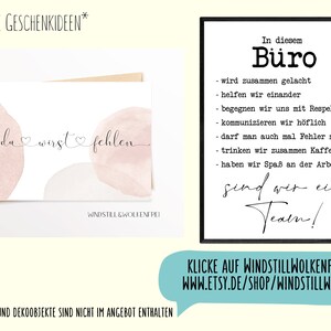 May include: A greeting card with the text "du wirst fehlen" in cursive, with watercolor-style pink and beige shapes. A framed sign with black text on a white background reads "In diesem B&uuml;ro" and lists office values. A teal banner with website information is at the bottom.