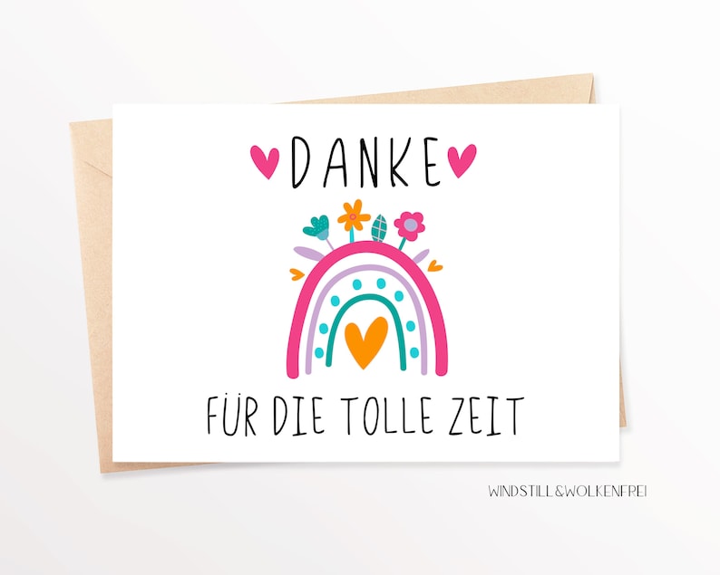 May include: A white card with a pink and purple rainbow with a yellow heart in the center. The rainbow has flowers on top and the text "DANKE" with hearts on either side. Below the rainbow is the text "F&Uuml;R DIE TOLLE ZEIT". The bottom of the card has the text "WINDSTILL & WOLKENFREI".
