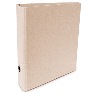 May include: A brown cardboard binder with a metal ring mechanism. The binder is closed and has a textured surface.
