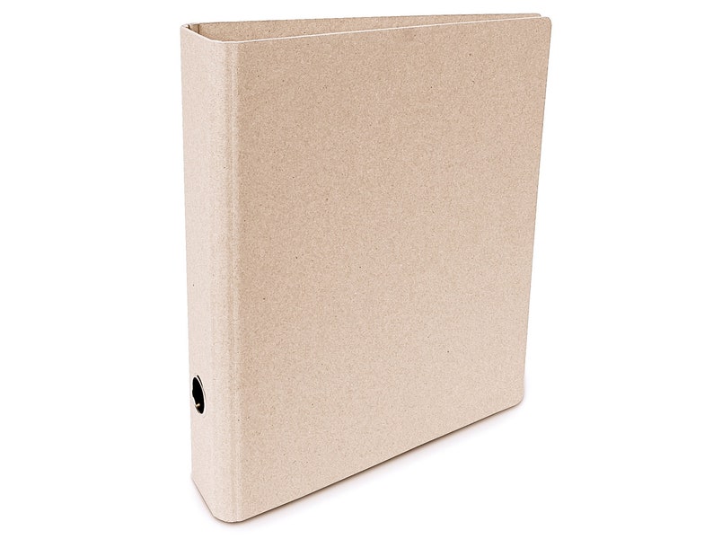 May include: A brown cardboard binder with a metal ring mechanism. The binder is closed and has a textured surface.