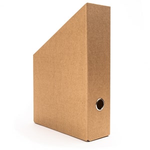 May include: A brown cardboard hanging file folder with a metal ring on the side.