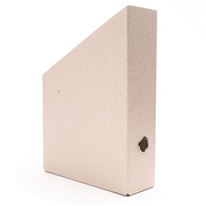 May include: A brown cardboard file folder with a metal ring binder mechanism.