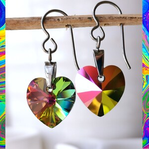 May include: A pair of silver heart-shaped earrings with iridescent rainbow crystals.
