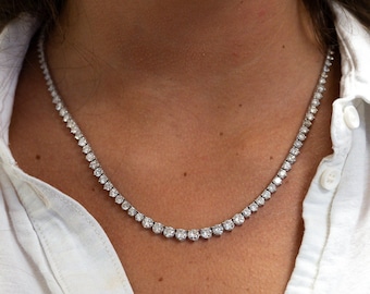 May include: A silver chain necklace with small round diamonds set in a continuous line.