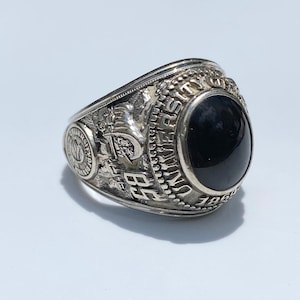May include: A silver class ring with a black stone and the inscription "University of Toledo 1967".