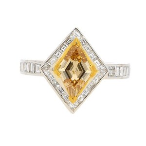 May include: A diamond ring featuring a yellow centre stone set in a diamond halo. The ring is crafted from white gold and has a square design.