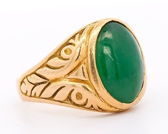 May include: A gold ring with an oval green gemstone set in a detailed, ornate design.