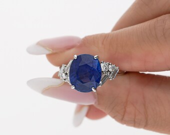 GRS Certified 6.35 Carat Royal Blue Oval Cut Natural Sapphire with Trillion & Round Cut Diamonds Ring in Platinum