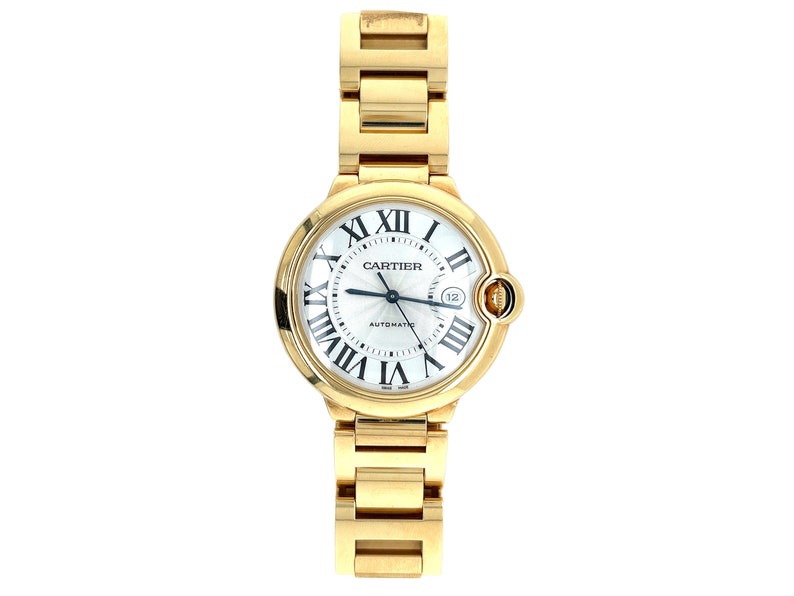 May include: A gold-tone Cartier Ballon Bleu watch with a white dial and Roman numeral hour markers. The watch has a round case and a gold-tone bracelet.