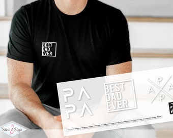 Op de afbeelding: Een wit grafisch ontwerp op een zwart T-shirt met de tekst "Best Dad Ever" in een vierkant. Het ontwerp is ook verkrijgbaar als sticker.