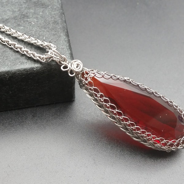 Sanguine Teardrop Blood Red Garnet with rosette and leaf accent set in braided Stainless Steel Setting