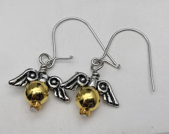 May include: A pair of silver earrings with gold spheres and winged accents.