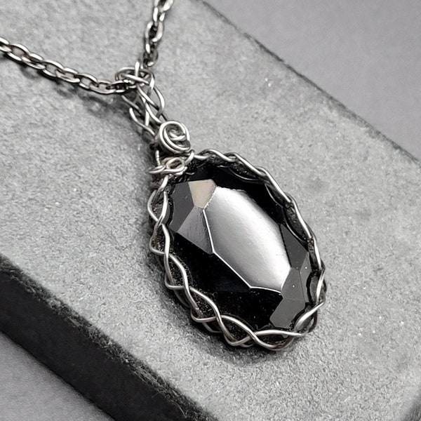 Wednesday. A faceted onyx in Gunmetal Steel  with rosette accent (mourning jewelry) pendant