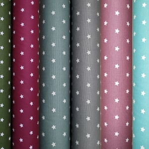 Meluna oilcloth from Swafing with stars in wine red, fir green, mint, light mint, gray, old pink. Acrylic coating, cotton, washable