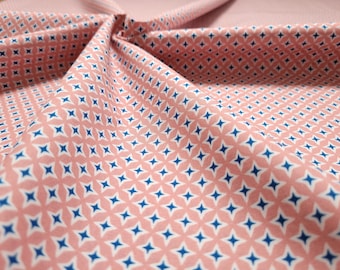 Cotton fabric from the Emilie series by Hilco. Salmon colored with blue and white stars.