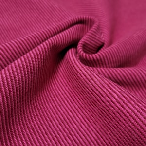 Peut inclure: Gros plan sur un tissu c&ocirc;tel&eacute; rose avec une surface textur&eacute;e.