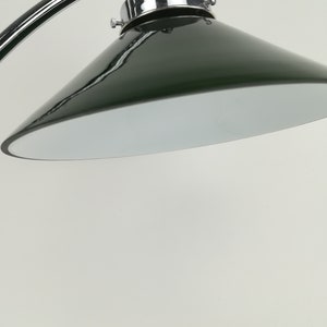 May include: A chrome and green metal lamp with a curved arm and a cone-shaped shade.