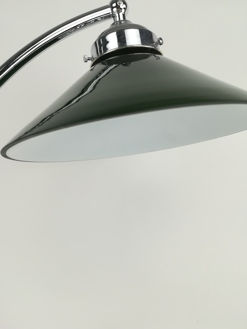 May include: A chrome and green metal lamp with a curved arm and a cone-shaped shade.