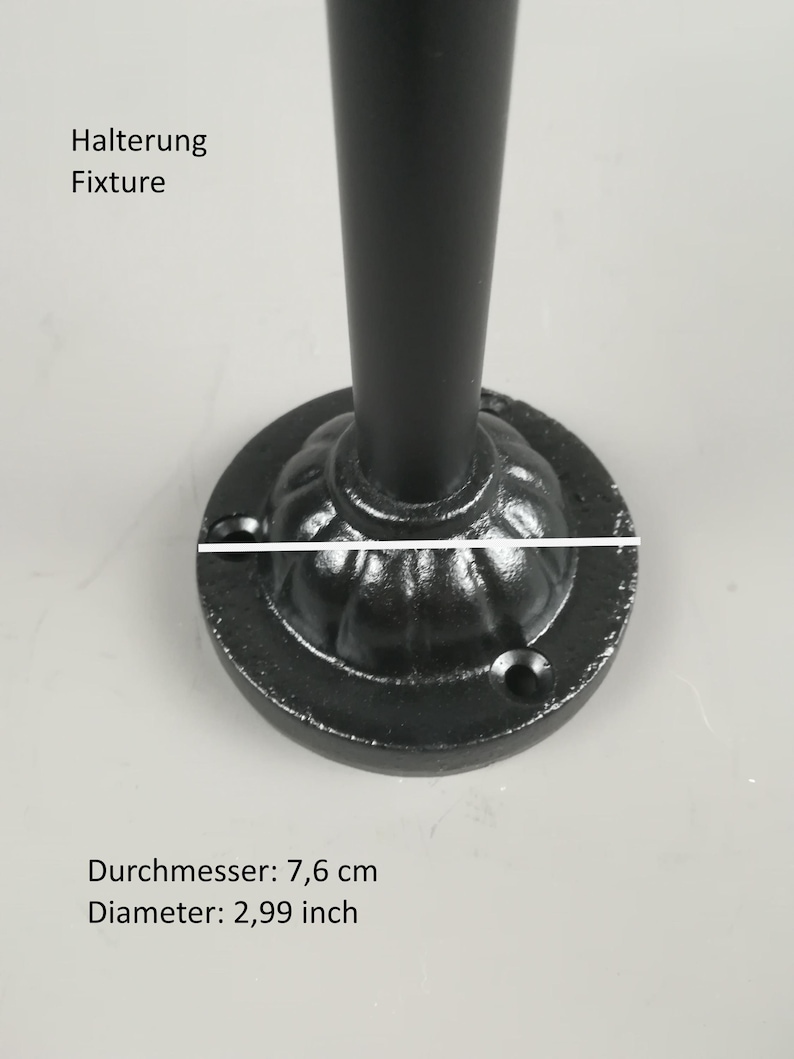 May include: Black metal fixture with a round base. The base has a decorative design and measures 3.00 inches in diameter.
