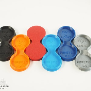 May include: Five 3D printed double-sided lens caps in different colours: black, orange, red, blue, and grey. Each cap has the text "MAM C LONG" and "FORSTER UK" printed on it.