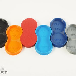 May include: Five different coloured plastic film canisters for a Mamiya C camera. The canisters are labelled "Mamiya C STD" and "FORSTER UK".