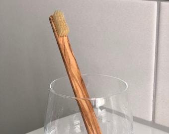 Toothbrush with handle made of olive wood
