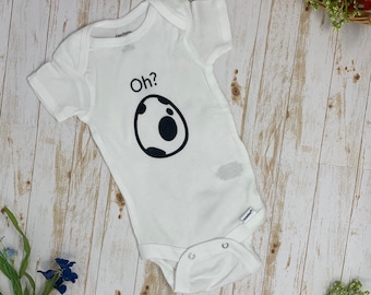 May include: White baby onesie with black text that says "Oh?" and a black and white cow print egg graphic.