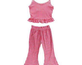 May include: A two-piece outfit featuring a red and white gingham pattern. The top is a camisole with spaghetti straps and a ruffled hem. The matching pants are flared at the bottom.