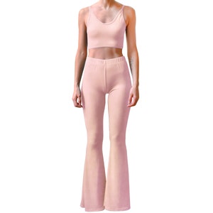 May include: A pink two-piece outfit with a cropped tank top and wide-leg pants.
