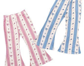 May include: Two pairs of flared pants. One pair is pink and white striped with a floral pattern. The other pair is blue and white striped with a floral pattern. Both pairs have an elastic waistband.