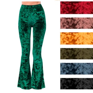 May include: Emerald green velvet flared pants. The high-waisted pants have a fitted top and wide, flowing bell bottoms. A color chart of velvet fabric swatches in red, brown, orange, olive, blue, and black is shown to the right of the pants.