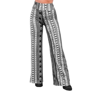 May include: Black and white wide-leg pants with a geometric pattern. The pants have a high waist and a relaxed fit.