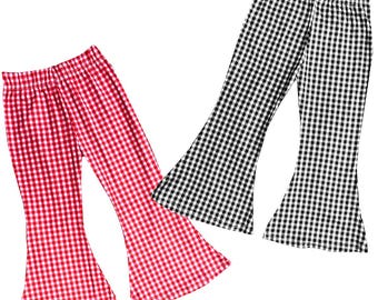 May include: Two pairs of flared pants. One pair is red and white checkered, the other is black and white checkered. The pants have an elastic waistband and a wide bell bottom. The fabric appears to be a lightweight material.