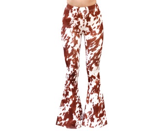 May include: Brown and white cow print bell bottom pants.
