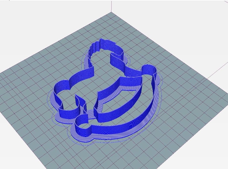 May include: A blue 3D-printed cookie cutter in the shape of a rocking horse. The cutter is on a grey surface with a grid pattern. The rocking horse design is detailed and has a smooth, rounded shape.