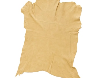 May include: A single piece of tan leather, irregularly shaped with a rough, textured surface. The leather is a light, warm tone, with visible folds and edges, suggesting it's a natural material. The background is plain white.