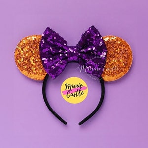 May include: Purple and orange sequined Minnie Mouse ears headband with a black headband and a yellow circle with the text "Minnie Castle" in black.