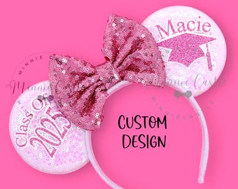 Pode incluir: Orelhas de Minnie Mouse cor-de-rosa com um laço cor-de-rosa, uma orelha diz "Class of 2025" e a outra orelha diz "Macie" com um chapéu de formatura.