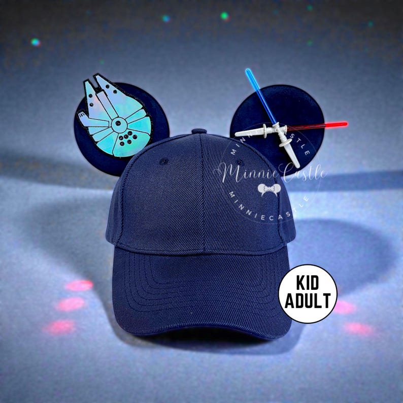 May include: A navy blue baseball cap with attached mouse ears. One ear features a Millennium Falcon design, the other a lightsaber design. The cap has the text "Minnie Castle" embroidered on the front. A sticker on the side reads "Kid Adult".