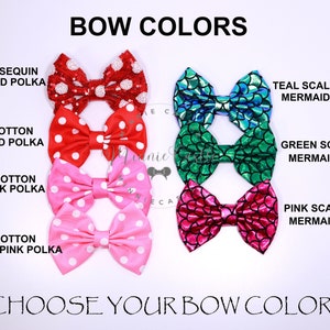 May include: A selection of fabric hair bows in various colors and patterns.  The bows include red polka dot, pink polka dot, light pink polka dot, teal mermaid scale, green mermaid scale, and pink mermaid scale.  Choose your bow color.