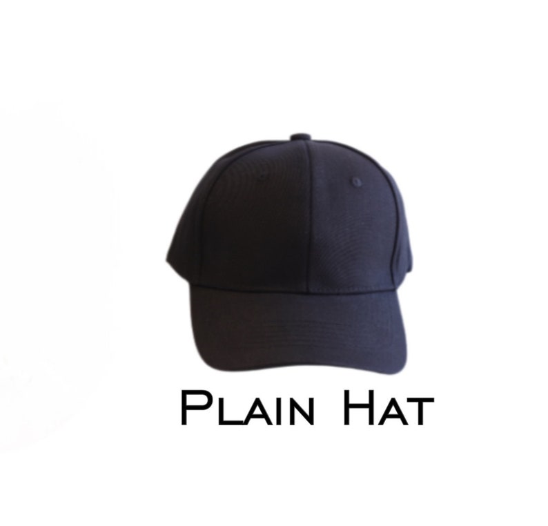 May include: A navy blue baseball cap with a curved peak. The cap features a rounded crown and a small button at the top. The text "PLAIN HAT" is printed in black below the cap.