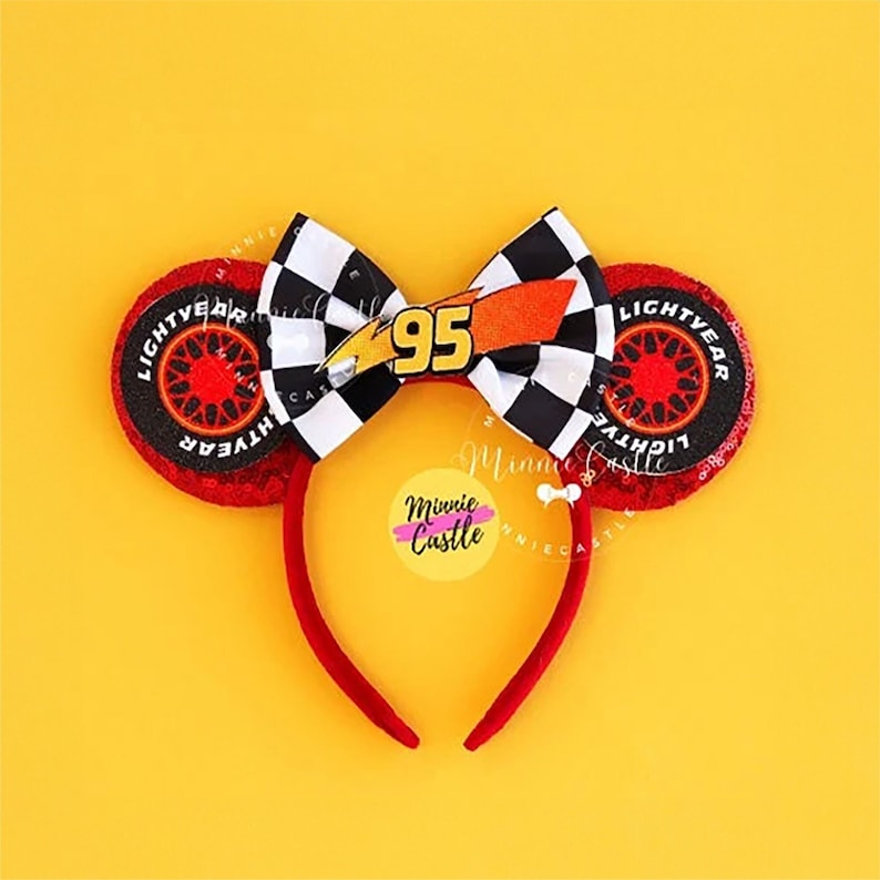 May include: Red Minnie Mouse ears with a black and white checkered bow with a lightning bolt and the number 95 on it. The ears are decorated with a red and black tire with the words 'Lightyear' on it.