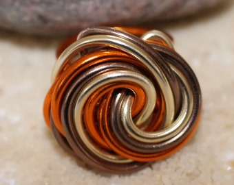 Beautiful hand-turned aluminum ring in the colors orange/brown/gold. Handcrafted / unique!!