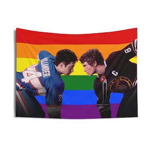 May include: A wall tapestry featuring two men in hockey jerseys facing each other against a rainbow flag background. One jersey is blue with the name "Ollander" and the number "4" on it. The other jersey is black with the number "8".